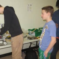 <p>Jack Phillips, left, captain of the robotics club at Mamaroneck High School, puts some finishing touches on this year&#x27;s robot entered in a Saturday First Tech Challenge competition at John F. Kennedy Catholic High School.</p>