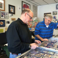 <p>Mike Healy, at left, and Dave Lancaster look through their collection at The Baseball Card Store in Midland Park.</p>