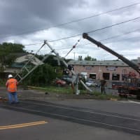<p>Metro-North crews work to repair a damaged gate after it was hit by a car.</p>