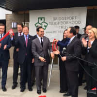 <p>HUD Secretary Julian Castro helps cut the ribbon at the Milestone Apartments in Bridgeport.</p>
