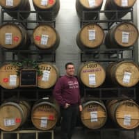 <p>John Gizzi Jr. helps his father run &quot;Make Wine With Us&quot; in Wallington.</p>