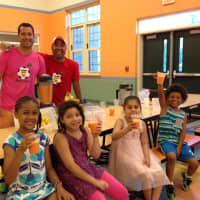 <p>Local dads Chad Dictenberg (left) and Andy Pada served up free healthy smoothies to the students at the Dr. John Grieco Elementary School in Englewood.</p>