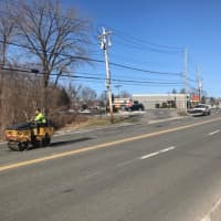 <p>A bulldozer smoothing over temporary pavement near McDonalds on Marble Avenue. Officials in Thornwood and Pleasantville are hoping the county will repave the entire pothole-ridden roadway after major nearby utility work by Con Edison.</p>