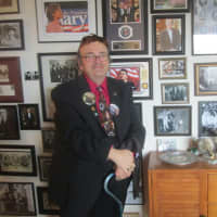 <p>William Reynolds stands in front of his wall of presidential memorabilia.</p>