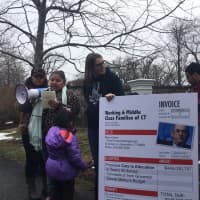 <p>Members of the Working Families Organization present billionaire Steven Cohen of Greenwich with a bill for $446,030,797.</p>