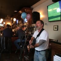 <p>Con O&#x27;Halloran serenades the crowd at the grand opening of The Castle on Post in Fairfield.</p>
