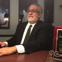 <p>Louis Aloia sits in an office at his Garfield Funeral home.</p>
