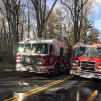 <p>Firefighters, including a crew from Wilton, tackle a blaze at a property at 610 Cheese Spring Road in New Canaan on Friday.</p>