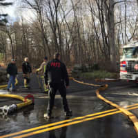 <p>Firefighters tackle a blaze at a property at 610 Cheese Spring Road in New Canaan on Friday. One crew from Pound Ridge, N.Y., responded.</p>