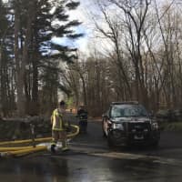 <p>Firefighters tackle a blaze at a property at 610 Cheese Spring Road in New Canaan on Friday.</p>