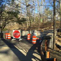 <p>Barriers block off the Old West Mill Road Bridge until crews opened the reconstructed bridge Monday.</p>