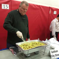 <p>George Wanamaker tends the Gotham City Diner table at &quot;A Taste of Our Town&quot; in Fair Lawn Monday night.</p>