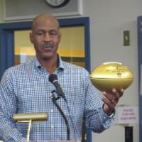 <p>Former White Plains High School star (and Pro Football Hall of Famer) Art Monk presenting the golden football.</p>