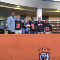 <p>Pro Football Hall of Famer Art Monk with members of the White Plains football team, Principal Ellen Doherty and Head Coach Skip Stevens.</p>