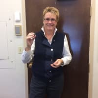 <p>Darlene Garrison shows a garnet to a visitor at Danbury Library.</p>