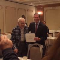 <p>U.S. Sen. Richard Blumenthal, right, presents John Boboc, 94, with a certificate honoring him for his military service during World War II. Boboc was a heavy machine gunner who landed on Omaha Beach with the D-Day invasion of Normandy.</p>
