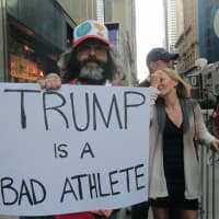 <p>Comedian Judah Friedlander with his own protest outside Trump Tower.</p>