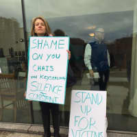 <p>Lisa Stuart of Wilton holds up a sign at the Stamford courthouse before the court appearance of a Greenwich politician charged with fourth-degree sexual assault.</p>