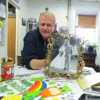 <p>Habitat for Humanity of Westchester Executive Director Jim Halloran showing off some of the memorabilia that will soon be auctioned off.</p>