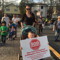 <p>Dumont residents march in protest of the proposed redevelopment of the former D&#x27;Angelo Farms site.</p>