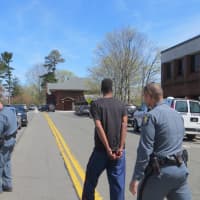 <p>Jean-Pierre Filtcher, 24, of New Rochelle being taken back to Westchester County Jail by state police after his court arraignment Tuesday afternoon at Harrison Town Court.</p>