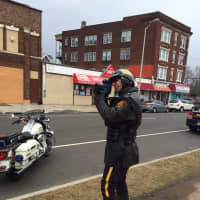 <p>Bridgeport Patrolman Richie Mercado uses a radar gun to clock motorists on State Street.</p>