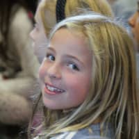 <p>Second-grader Mia Jones enjoys the show at Royle Elementary.</p>