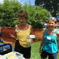 <p>Mimi Greenlee and Suzy Hooper, the book sale&#x27;s chief volunteer finder, eye one of the cakes.</p>