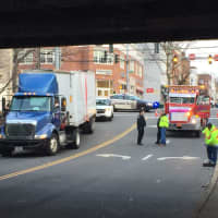 <p>Police stand by after a truck that had been wedged under the Steamboat Road railroad bridge overpass Tuesday morning is freed.</p>