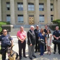 <p>New Rochelle residents Jessica Levine and Jennifer Ubl presenting the police department with new bulletproof vests for the K9 unit.</p>