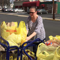 <p>Laura Sabatello loads groceries at the Fair Lawn Food Pantry Wednesday.</p>