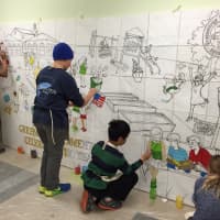 <p>Kids painting Betsy Franco Feeney&#x27;s mural</p>