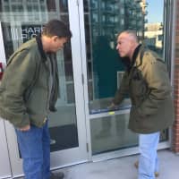<p>Stamford police Investigator Frank Laccona, right, points out the area where a bullet hit at 111 Towne St. to Sgt Paul Guzda on Monday.</p>