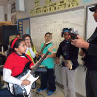 <p>Latin Grammy nominee and Yankees legend Bernie Williams plays with students at Tisdale School.</p>