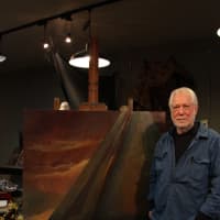 <p>Max Horbund poses with one of his semi-abstracted paintings.</p>