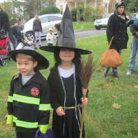 <p>A firefighter and a witch march in the Briarcliff Ragamuffin Parade.</p>