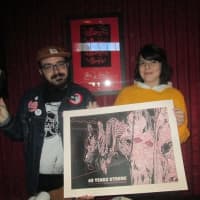 <p>Justin LaLiberty and Nicole Testa helped run the Rocky marathon, giving out prints and action figures.</p>