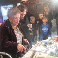 <p>Clara Fontana cuts the cake at her 107th birthday party.</p>