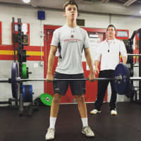 <p>Bergen Catholic senior Billy McKee deadlifts an easy 135 pounds with encouragement from strength and conditioning coach Richard Robinson.</p>