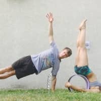 <p>Michael Taylor and Jessica Morfa using yoga wheels.</p>