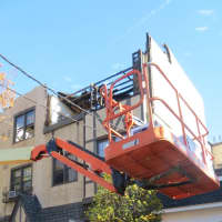 <p>A bulldozer clearing debris nearby the fire ravaged apartment building at 1912 Palmer Ave. earlier this week. A corner of the top floor was noticeably damaged.</p>