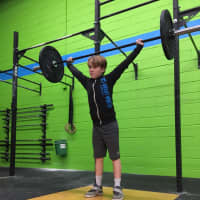 <p>Demonstrating a snatch with the bar he got for Christmas.</p>