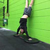 <p>Liam bangs out handstand push-ups in Great White.</p>