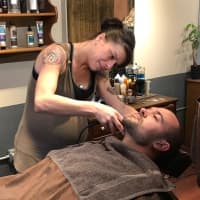 <p>A Stag House barber shaves a Glen Rock police officer.</p>