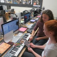 <p>Hannah Israel, front, and Anna Daum, make music with a handmade gadget -- basically, cardboard and copper wires -- that is hooked up to a computer. The Hommocks Middle School&#x27;s new eMusic Lab was officially launched Tuesday.</p>