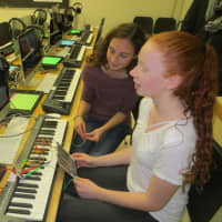 <p>Eighth-graders Hannah Israel, front, and Anna Daum, use a &quot;Makey-Makey&quot; to create music in the new eMusic Lab at Hommocks Middle School Tuesday.</p>