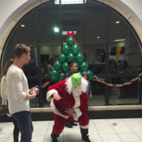 <p>Santa dances during the event hosted by students and parents.</p>