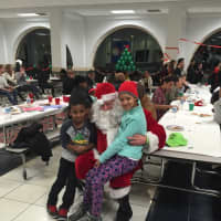 <p>Children visit with Santa while enjoying a meal.</p>