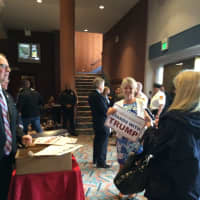 <p>Trump fans snap up free signs to wave before going into the auditorium Saturday.</p>