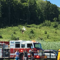 <p>Fire and police are on the scene of plane crash on a hill above the dog park near the Danbury Airport on Sunday morning.</p>